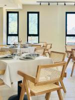 a dining room with tables and chairs and windows at Thymises Boutique Hotel in Kakopetria