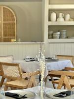 a dining room with a table and chairs and plates at Thymises Boutique Hotel in Kakopetria