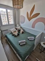a bedroom with a bed with pillows on it at Massilia Calling love Appartement de standing 8 personnes Marseille proche métro parking facile in Marseille