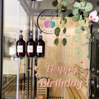 a happy birthday sign in a window with three bottles of wine at BIOTY CHILL &amp; SPA in Le Blanc-Mesnil