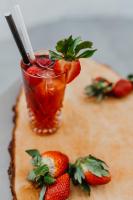 a drink on a cutting board with strawberries on it at Hotel Saltic Resort & Spa Grzybowo in Kołobrzeg