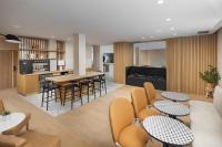 a dining room and kitchen with tables and chairs at Residence Inn by Marriott Paris Didot Montparnasse in Paris