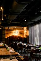 a dining room with tables and chairs and lights at Bobby Hotel in Nashville