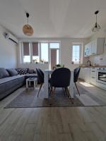 a kitchen and living room with a table and chairs at Apartman REA 1 in Pirot