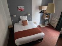 a bedroom with a large bed in a hotel room at Hôtel les Platanes in Villeneuve-sur-Lot