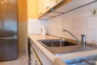 a kitchen with a sink and a stainless steel refrigerator at Apartment Duje in Split