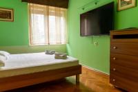 a green bedroom with a bed and a dresser at Apartment Duje in Split