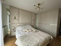 a bedroom with a large white bed with two pillows at Appartement Luxueux 3 pièces climatisé avec Terrasse, 5 couchages - 17ème Arrondissement de Paris in Clichy