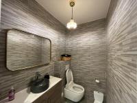 a bathroom with a sink and a toilet and a mirror at Appartement Luxueux 3 pièces climatisé avec Terrasse, 5 couchages - 17ème Arrondissement de Paris in Clichy