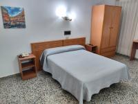 A bed or beds in a room at Hotel Cogullada