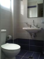 a bathroom with a toilet and a sink at Raymondos Apartments in Lassi