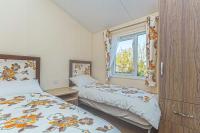 Postel nebo postele na pokoji v ubytování Bodafon Park Lodge