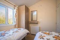 Postel nebo postele na pokoji v ubytování Bodafon Park Lodge