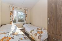 Postel nebo postele na pokoji v ubytování Bodafon Park Lodge