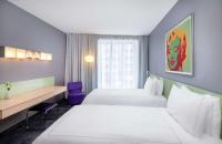 Ein Bett oder Betten in einem Zimmer der Unterkunft Park Plaza Berlin