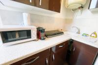 a kitchen with a counter top with a microwave at The Golfer&#39;s Nest #FP in Vaulnaveys-le-Haut