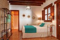 Posteľ alebo postele v izbe v ubytovaní SUITES CASA DE LAS COLUMNAS