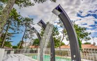 a water fountain in front of a swimming pool at 2 Bedroom Beautiful Home In La Faute-sur-mer in La Faute-sur-Mer