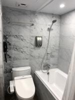 a bathroom with a toilet and a sink and a shower at Dynasty Hotel in Tainan
