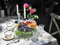 a table with a cake and a vase of flowers at Blu Monkey Pooltara Krabi Hotel & Villas Pet Friendly in Tha Lane Bay