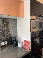 a kitchen with a counter with a oven and a sign at Spacieux T3 haussmannien in Toulon