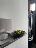 a bowl of apples sitting on a counter next to a refrigerator at Spacieux T3 haussmannien in Toulon