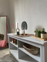 a white console table with plants and candles on it at Spacieux T3 haussmannien in Toulon