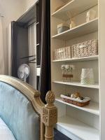 a bedroom with a bed and shelves with baskets at Spacieux T3 haussmannien in Toulon