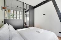 a bedroom with a white bed and a window at GemBnB Luxury Apartments - Sedaine in Paris