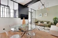a living room with a glass table and a couch at GemBnB Luxury Apartments - Sedaine in Paris