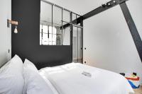 a bedroom with a white bed and a black wall at GemBnB Luxury Apartments - Sedaine in Paris