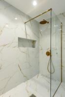 a white marble bathroom with a glass shower at SeãCret in Kolymvari