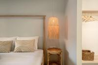 a bedroom with a bed and a pendant light at SeãCret in Kolymvari