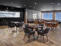 a restaurant with tables and chairs in a room at Element Edmonton West in Edmonton