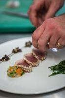 a person holding a piece of food on a plate at Logis Hôtel Auberge du Cheval Blanc in Yvoy-le-Marron