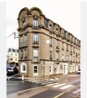 a large brick building on a city street with a street at Résidence Bellevue in Wimereux