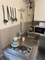 a kitchen counter with a sink and utensils on the wall at Résidence Bellevue in Wimereux