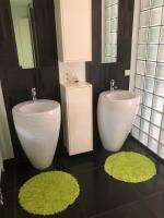 a bathroom with two toilets and a sink and mirrors at landelijke villa met zwembad en gezellige openhaard in Zemst
