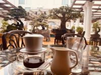 Una mesa de cristal con una taza de café y una jarra. en Khách sạn Phương Anh, en HÆ°ng YÃªn