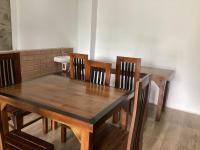 a wooden table with four chairs and a sink at Mountjoy Ella in Ella