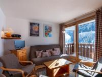a living room with a couch and a tv and a balcony at Appartement Méribel, 3 pièces, 6 personnes - FR-1-355-48 in Méribel