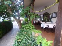 a restaurant with tables and chairs and a tree at APARTMENT DELUXE MARINA CAPE 4 stars complex 33 6 in Aheloy