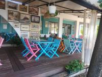a restaurant with colorful chairs and tables on a wooden deck at APARTMENT DELUXE MARINA CAPE 4 stars complex 33 6 in Aheloy