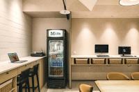 a drink refrigerator in a restaurant with a counter at Orange Hotel - Ximen, Taipei in Taipei