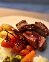 a plate of food with meat tomatoes and vegetables at Residenza 3544 in Lumino