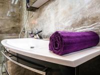 a purple towel sitting on a sink in a bathroom at Luxurious Apartment in Zadar with Garden in Arbanasi
