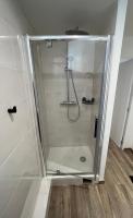 a shower with a glass door in a bathroom at Bienvenue chez Tom in Lamballe