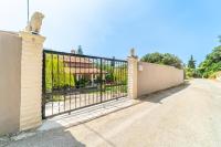 an iron gate in front of a house at Giourgas house in Chlomatianá