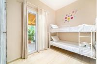 a room with two bunk beds and a window at Giourgas house in Chlomatianá