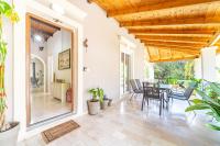 an indoor dining room with a table and chairs at Giourgas house in Chlomatianá